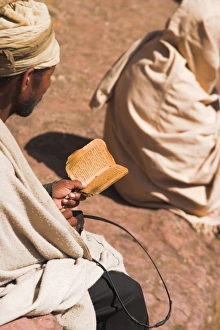 Holy Book Prints: Pilgrim reads Holy Bible in Bet Maryam (St. Mary s) courtyard, Lalibela