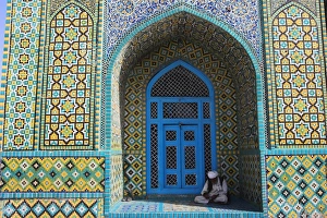 Pilgrim sits in a niche at the Shrine of Hazrat Ali, who was assassinated in 661