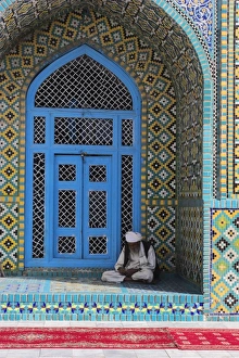 Pilgrim sits in a niche at the Shrine of Hazrat Ali, who was assassinated in 661