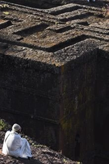 Contemplating Gallery: Pilgrim in traditional white shawl at the rock hewn monolithic church of Bet Giyorgis (St