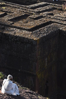 Contemplating Gallery: Pilgrim in traditional white shawl at the rock hewn monolithic church of Bet Giyorgis (St
