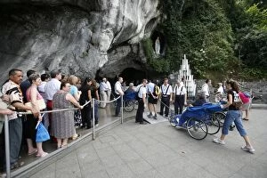 Pilgrims at the Lourdes grotto, Lourdes, Hautes Pyrenees, France, Europe