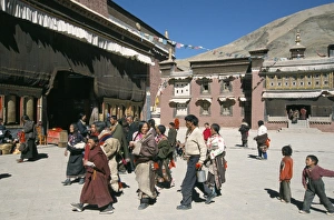 Tibetan Ethnicity Prints: Pilgrims in monastery courtyard. Sakya, Tibet, China, Asia