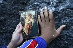 Images Dated 20th April 2000: Pilgrims touching the Lourdes grotto, Lourdes, Hautes Pyrenees, France, Europe