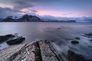 Nordland Gallery: Pink Arctic sunrise over snowcapped mountains and frozen fjord, Vareid, Flakstad, Nordland county