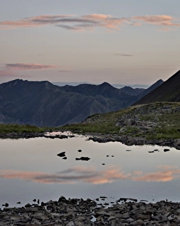 Tarn Prints: Pink clouds at dawn reflected in a tarn near Stony Pass