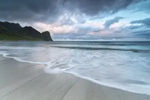 Moody Sky Prints: Pink clouds of midnight sun reflected on the blue sea and sandy beach, Unstad, Vestvagoy