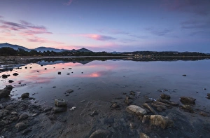 Pink clouds at sunset are reflected in the blue sea, Villasimius, Province of Cagliari