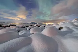 Svolvaer Prints: The pink light and the aurora borealis (Northern Lights) illuminate the snowy landscape