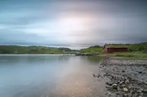 Rorbu Prints: Pink lights of the midnight sun illuminate sea and the typical rorbu, Holdalsvatnet