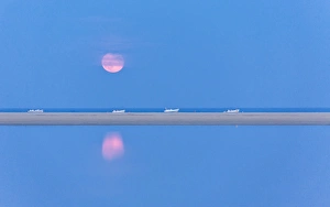 Villasimius Prints: The pink full moon is reflected in the blue water of the Notteri pond, Villasimius