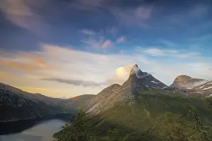Tysfjord Prints: Pink sky and midnight sun light up the rocky peak of the Stetinden mountain surrounded by sea