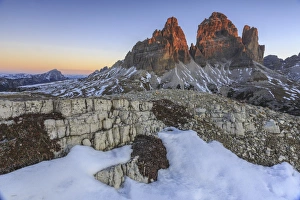 Jagged Prints: Pink sky at sunrise frames the Three Peaks of Lavaredo, Dolomites, Auronzo of Cadore