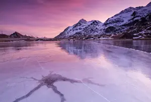 Pink Sky Prints: Pink sky at sunset on the frozen Lej Nair framed by snowy peaks