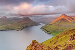 Pink sunrise over mountains and cliffs along Funningur fjord, Eysturoy Island, Faroe Islands, Denmark, Europe