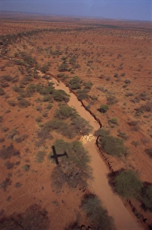 Plane flying over sand river or lugga which may only flow with water a few days each year Plane flying over sand river or lugga which may only flow with water a few days each year