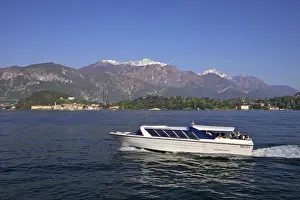 Lombardia Prints: Pleasure boat crossing Lake Como from Bellagio in spring sunshine