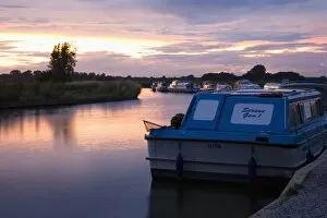 Pleasure boats moored on the River Ant, sunset, Norfolk Broads, Ludham