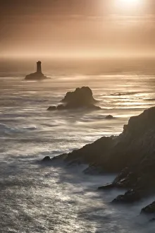 Pointe du Raz lighthouse and cliffs at sunset in Finisterre, Brittany, France, Europe Pointe du Raz lighthouse and cliffs at sunset in Finisterre, Brittany, France, Europe
