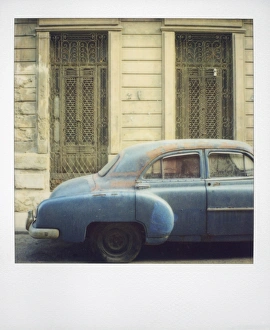 Dusty Prints: Polaroid of old blue American car covered in dust, Havana, Cuba, West Indies