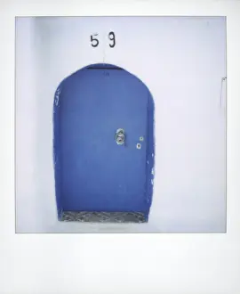 Photographic Techniques Prints: Polaroid of traditional painted blue door against whitewashed wall