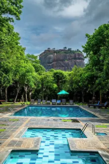 Swimming Prints: Pool view in a hotel before a large rock fortress in Central Province