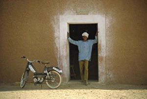 One Young Man Only Prints: Portrait of man standing in doorway, Niger, Africa