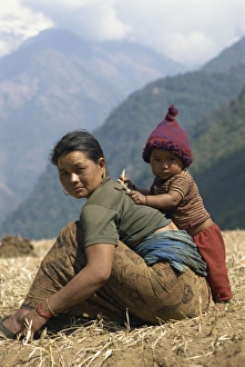 Portrait of a mother and son in a field in Nepal