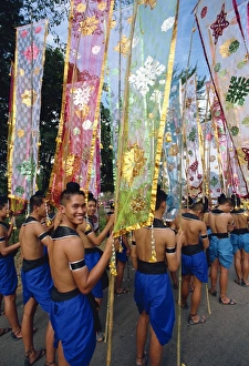 Thai Ethnicity Prints: Portrait of a smiling man in a parade of colourful