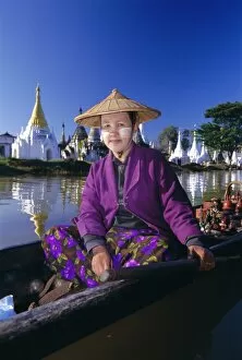 Wear Collection: Portrait of a woman in a boat, wearing a straw hat and face paste, Phaung Daw U Kyaung