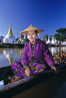 Shan State Prints: Portrait of a woman in a boat, wearing a straw hat and face paste, Phaung Daw U Kyaung