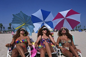 Parasol Prints: Portrait of three women wearing sunglasses and swimwear