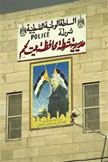 Posters Prints: Poster showing Yasser Arafat on the wall of a Palestinian Police Station in Bethlehem