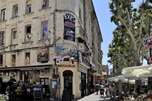 Avignon Prints: Posters advertising the theatre festival on a building with pictures painted on the windows