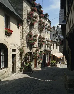 Dinan Prints: Pots and windowboxes of geraniums on houses on the Rue de Jerzual in Dinan