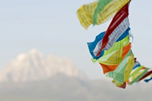 Sichuan Prints: Prayer flags blowing in wind, Snow mountain, Tagong, Sichuan, China, Asia