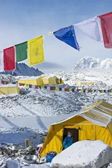 Prayer flags and the Everest base camp at the end of the Khumbu glacier that lies at 5350m