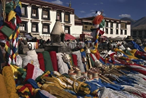 Tibet Prints: Prayer wheels and flags for sale in the Barkor market in Lhasa, Tibet, China, Asia