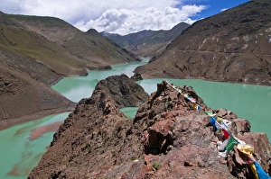 Images Dated 6th August 2010: Praying flags above an artifical lake near the Karo-La Pass, Tibet, China, Asia