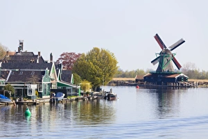 Preserved historic windmills and houses in Zaanse Schans, a village on the banks of the River Zaan, near Amsterdam, a tourist attraction and working museum, Zaandam, North Holland, Netherlands, Europe