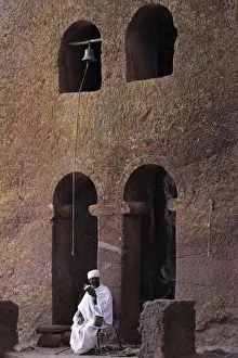 Priests Prints: Priest reading a Bible in Bet Maryam church courtyard, UNESCO World Heritage Site