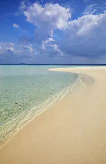 Crystal Prints: Pristine shallow waters lap against the white coral sand of a tropical beach; Havodda Island
