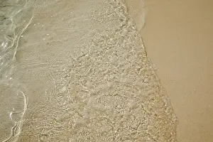 Warmth Prints: Pristine shallow waters lap against the white coral sand of a tropical beach; Havodda Island