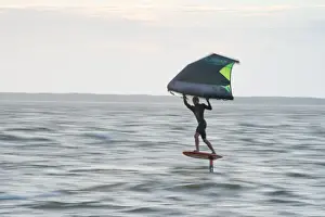 Young Man Prints: Pro surfer James Jenkins flies above the Atlantic Ocean on his wing surfer at Nags Head