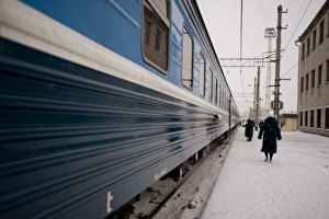 Images Dated 28th January 2009: Providnistas remove snow and ice from the under the train, Trans-Siberian railway