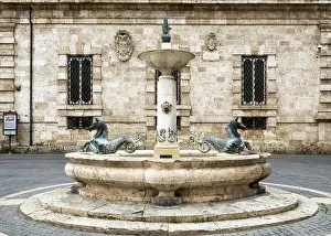 Marche Prints: Public drinking water fountain with bronze seahorses on the Piazza Arringo
