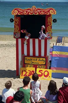 Children Prints: Punch & Judy show on the beach at Swanage, Dorset, England, United Kingdom, Europe