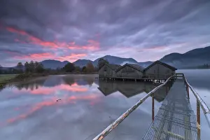 Wooden Hut Prints: Purple sky at sunset and wooden huts are reflected in the clear water of Kochelsee
