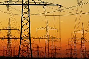 Orange Colour Prints: Pylons and power lines in morning light, Germany, Europe