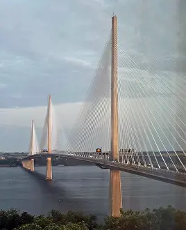 Support Prints: Queensferry Crossing Bridge connects two locations over water in Edinburgh Scotland with vehicles moving across